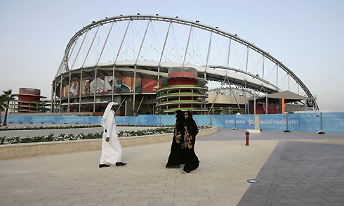 Visitors walk outside the Khalifa Stadium a day before the start of the 15th Asian Games in Doha November 30, 2006. 