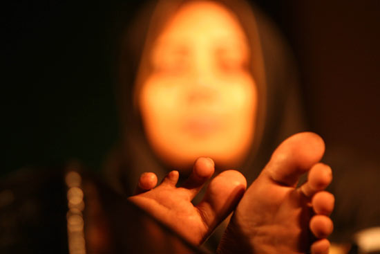 Rima, a bomb victim, who attended a convention against terrorism in Dhaka, Bangladesh, on August 30, 2005, sits back to relax. She was injured in a bomb attack and lost some of her toes.