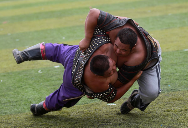 Wrestling is one of the 'three manly skills' of the Mongolian ethnic group. The sport, along with horsebacking riding and archery, forms the basis of the competition at the annual Nadaam festivals. Photos by Cui Meng / China Daily One-time nomads hang on to traditional celebrations