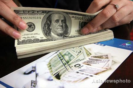 Nation may cut its dollar holdings