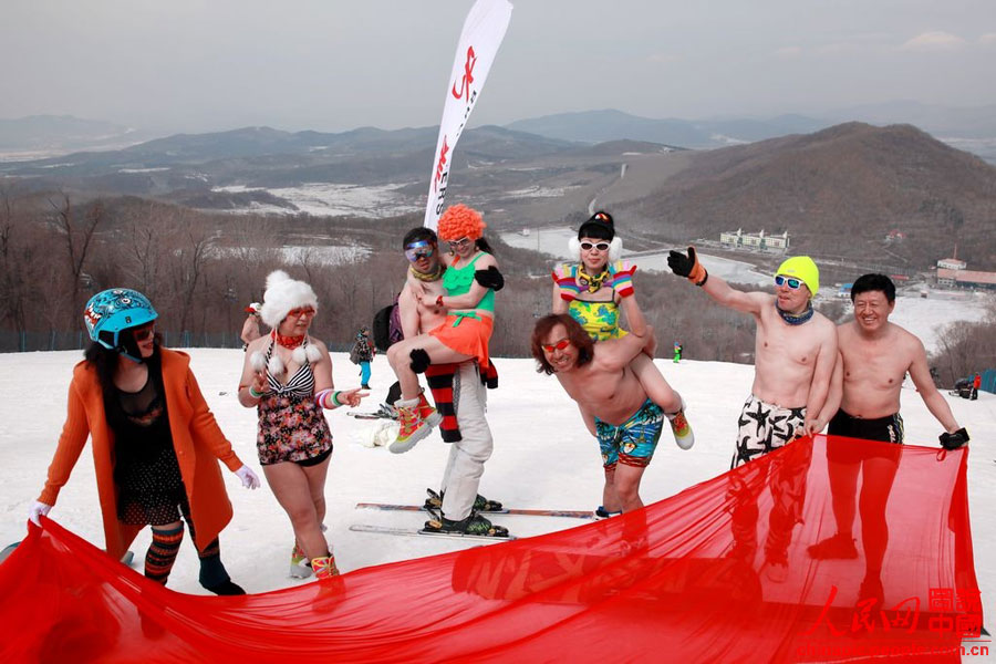 Skiers in swimsuit bid farewell to ski season