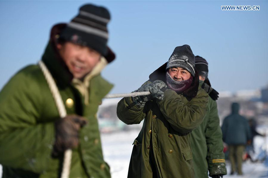 Winter fishing in ice-covered Changling Lake in Harbin