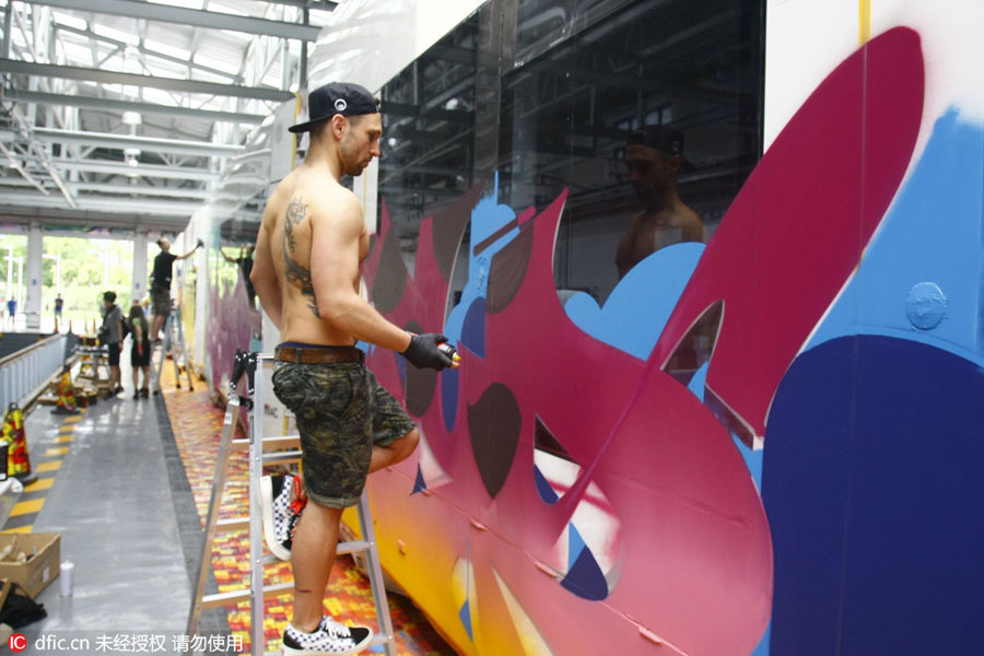 Chinese and foreign graffiti artists decorate trolley in Guangzhou