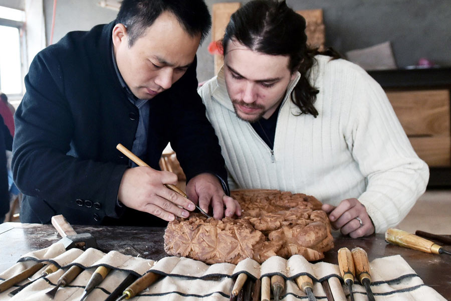 Frenchman engrossed by Dongyang wood carving