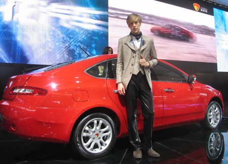 Model poses next to Lotus car