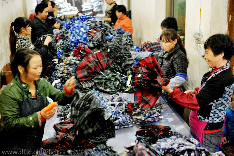 Women make umbrellas for export in Jiangxi