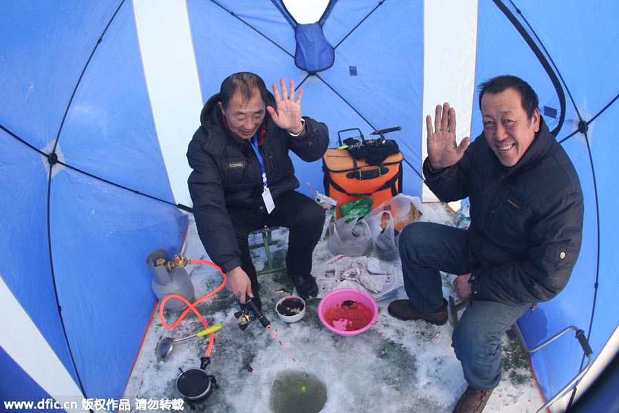 Winter fishing in ice-covered Changling Lake in Harbin
