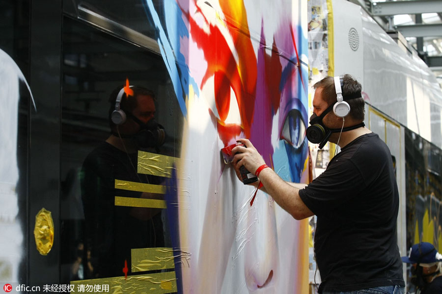 Chinese and foreign graffiti artists decorate trolley in Guangzhou