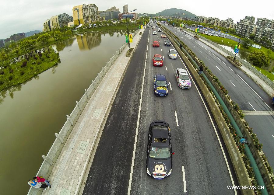 Cars with colorful cartoon drawings parade in Hangzhou