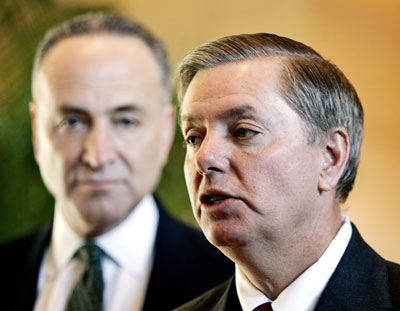 U.S. Senators South Carolina Republican Lindsey Graham (R) and Charles Schumer, a New York Democrat, talk to the media at a hotel lobby in Beijing March 22, 2006. A U.S. senator threatening sanctions unless China revalues the yuan said he wanted to learn whether there was "a pattern of progress" in the currency's quickening rate of climb. Schumer is co-author with Graham of a bill that would impose a tariff of 27.5 percent on Chinese imports into the United States unless Beijing revalues the yuan "at or near its fair market value." 