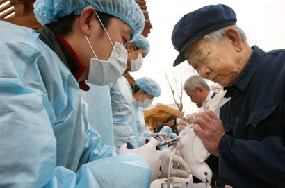 Residents, as arranged by the local authorities, get their birds vaccinated against bird flu in a park in Beijing March 31, 2006. The H5N1 bird flu virus has infected 16 people in China, of whom 11 have died. The virus is now endemic in poultry across much of the world, despite widespread culling of birds and mass vaccinations of fowl. 