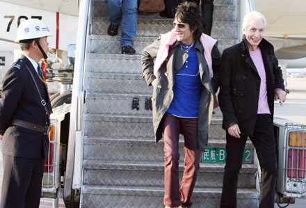 Ron Wood (C) and Charlie Watts (R) of the Rolling Stones arrive at the Pudong international airport in Shanghai, China April 6, 2006. The band arrived in Shanghai on Thursday afternoon in preparation for a concert on Saturday, their third attempt to play in China.