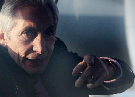 Charlie Watts of the Rolling Stones gestures as he sits in a bus upon arrival at the Pudong international airport in Shanghai, China April 6, 2006. The band arrived in Shanghai on Thursday afternoon in preparation for a concert on Saturday, their third attempt to play in China.
