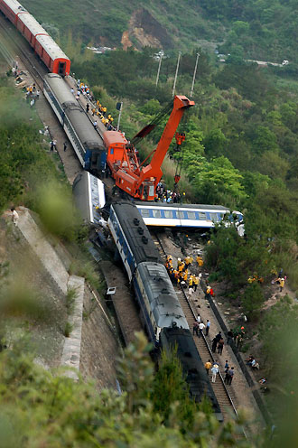 Two passenger trains collided in Heping County in South China's Guangdong Province, April 11, 2006. The accident killed two workers aboard the trains and injured dozens of others. The railway is part of the track linking Beijing and Kowloon in Hong Kong. [Xinhua] 