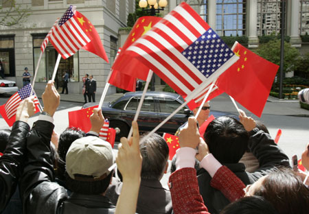 Supporters wave flags as the motorcade bringing Chinese President Hu Jintao arrives at his hotel in Seattle April 18, 2006. Hu is visiting the Seattle area for two days before heading to Washington D.C. for meetings with U.S. President George W. Bush. [Reuters]