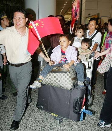 Solomon Islanders of Chinese descent arrive at an airport in Guangzhou, capital of the southern Chinese province of Guangdong, early April 25, 2006. More than 300 Chinese, including Hong Kong residents, boarded a chartered flight provided by Beijing that evacuated them from the troubled Solomon Islands after recent riots in Honiara.