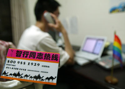 A volunteer answers a call to the hotline for gays in Shanghai May 11, 2006. The hotline, 800-988-1929, has offices in Shanghai as well as Guangzhou in south China's Guangdong Province. Hotline volunteers, all gays, will help their comrades on questions as AIDS, psychological and legal issues. The aim of this hotline is "gays helping gays." [newsphoto]