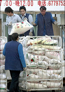 Workers unload the bags of flour from a truck, outside a supermarket in Beijing. The United Nations children's fund urged China to take a simple and cheap step to reducing problems such as anemia and facial clefts in kids -- by fortifying wheat flour.(AFP/File