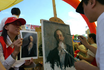 Painters compete during a facsimile match in Dafen Village, Shenzhen City, south China's Guangdong Province, Thursday, May 18, 2006. More than 110 contestants make facsimile of portrait or scenery oil painting in the timed game held in the village which is famous for its oil painting facsimile industry. [AP Photo]