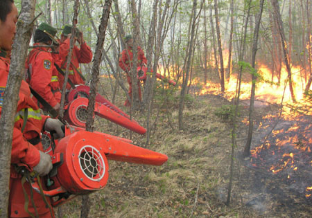 Chinese firemen board an helicopter on their way to put out forest fire in Heihe