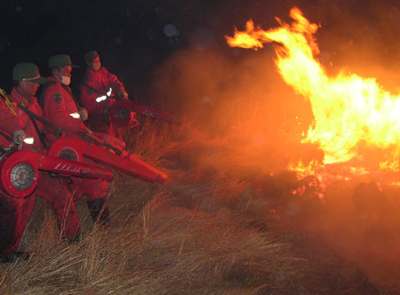 Chinese firemen board an helicopter on their way to put out forest fire in Heihe
