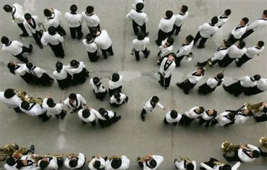 Students prepare to perform at a school event that aims to promote Olympic spirit and knowledge among youths in China in Beijing Friday, June 2, 2006. China is naming 500 Olympic model schools nationwide to help push forward the implementation of the Olympic education program, involving two hours of extracurricular activities in arts and exercise. Some 9.5 million young people will take the June 7-8 college entrance exams, but only one in four will be eligible for college enrollment, the official Xinhua News Agency said. The Chinese government last month said it plans to further restrict enrollment to improve teaching conditions and ease graduate employment pressures. (AP 