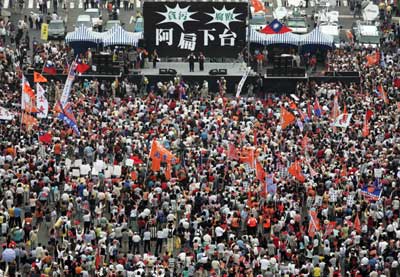Thousands of Taiwanese protesters gather before a large stage at a rally calling for President Chen Shui-bian to step down over an insider-trading scandal involving his son-in-law in Taipei June 3, 2006. The banner at the back of the stage reads: "Ah-bian step down," referring to Chen's nickname.