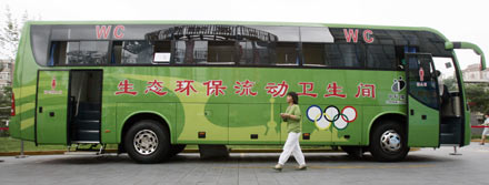 A woman alights from an ecological and environmental friendly mobile toilet bus, during the Saving Water Toilet Exhibition for the Beijing Olympics in Beijing June 7, 2006. [Reuters]
