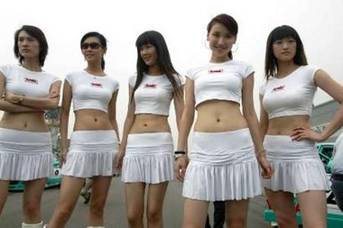 Pit girls pose for a photo during 2006 Asian Festival of Speed (AFOS) in Beijing, June 11, 2006. The Beijing leg of the Asian Festival of Speed had fast cars, scantily-clad pit girls, high speed crashes and other things pleasing to track-side spectators. Picture taken June 11, 2006. [Reuters]