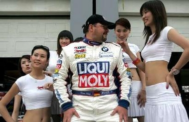 Team Engstler's driver Andreas Klinge looks at a pit girl as they pose for a photo during 2006 Asian Festival of Speed (AFOS) in Beijing, June 11, 2006. The Beijing leg of the Asian Festival of Speed had fast cars, scantily-clad pit girls, high speed crashes and other things pleasing to track-side spectators. Picture taken June 11, 2006. [Reuters]