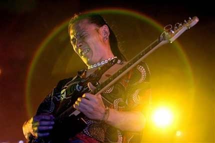 A member from the Chinese heavy metal rock band Tang Dynasty performs during a concert directed by Chinese rock music icon Cui Jian to mark the 20th anniversary of rock music in China held at an indoor stadium in Shenyang, north China's Liaoning province, June 16, 2006. Cui Jian introduced rock music to China with his song 'I Own Nothing' in 1986. [AP Photo]