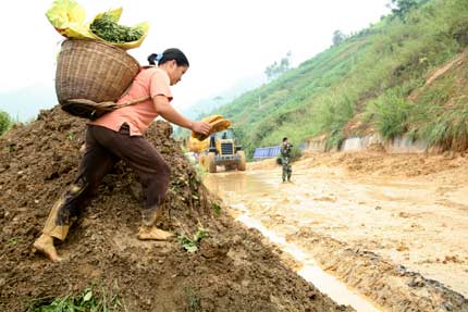 A Chinese woman walks through an area destroyed by floods in Wangmo, southwest China's Guizhou province, June 17, 2006. Heavy rainstorms hit Wangmo again, where flash floods have killed at least 52 people, with another 20 still missing earlier this month, Xinhua reported.