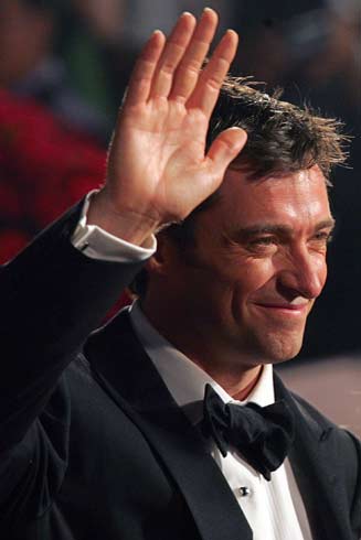 Actor Hugh Jackman waves to the audience during the opening ceremony of the Shanghai International Film Festival at the Shanghai Concert Hall June 17, 2006.