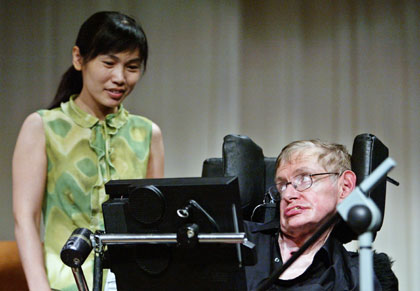 Stephen Hawking from the University of Cambridge, one of the world's leading theoretical physicists, is greeted by a Chinese student in Beijing June 21, 2006. Hawking said on Wednesday he feared global warming could have a devastating effect on Earth.