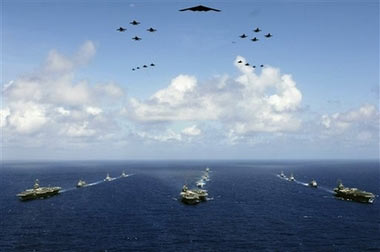 The USS Abraham Lincoln, USS Kitty Hawk and USS Ronald Reagan carrier strike groups steam in formation during a joint photo exercise (PHOTOEX) in preparation for Valiant Shield 2006 on Sunday, June 18, 2006, in the Pacific Ocean. The PHOTOEX featured 14 ships as well as 17 aircraft from Air Force, Navy, and Marine Corp including a B2 bomber. The Kitty Hawk Carrier Strike Group is currently participating in Valiant Shield 2006, the largest joint exercise in recent history. Held in the Guam operating area beginning June 19-23, the exercise involves 28 Naval vessels including three carrier strike groups, more than 300 aircraft and more than 20,000 service members from the Navy, Air Force, Marine Corps, and Coast Guard. 
