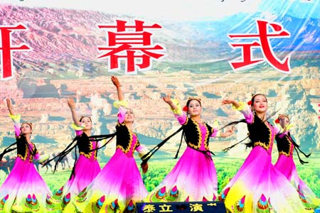 Uygur girls perform dances at the opening ceremony of the third Xinjiang International Tourism Festival as well as the 15th China Silk Road Turpan Grape Festival Wednesday, June 28, 2006. The event will last two months until August 28, 2008. [newsphoto]