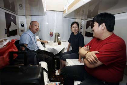 Passengers chat inside their compartment on board the first Beijing-to-Lhasa train moments before it leaves the Beijing railway station July 1, 2006