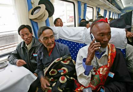 Passengers sit on board the first train at Lhasa railway station as it heads for Lanzhou in Gansu province July 1, 2006. 