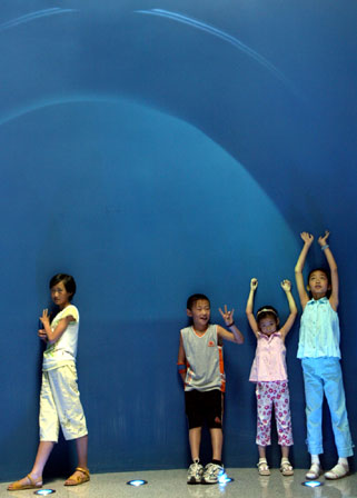 A little girl muses over life possibilities on Mars at the Beijing Planetarium, where an exhibition on the birth of the solar system opened yesterday. 