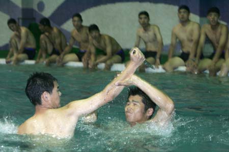 Chinese special policemen train in a swimming pool in Zhengzhou, Central China's Henan Province, July 12, 2006. [Zhao Ke/China Foto Press]