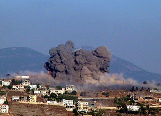 Smoke rises from Khiam village after being hit by Israeli air strikes, in southern Lebanon, July 25, 2006.