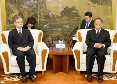 Japanese ambassador to China Yuji Miyamoto (L) listens as China's Foreign Minister Li Zhaoxing reads from a prepared statement in Beijing August 15, 2006, protesting the visit by Japanese Prime Minister Junichiro Koizumi to the Yasukuni Shrine. China accused Koizumi on Tuesday of "wrecking the political foundations of China-Japan relations" by visiting the shrine that honours Japanese leaders convicted as war criminals. 