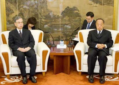 Japanese ambassador to China Yuji Miyamoto (L) listens as China's Foreign Minister Li Zhaoxing reads from a prepared statement in Beijing August 15, 2006, protesting the visit by Japanese Prime Minister Junichiro Koizumi to the Yasukuni Shrine. China accused Koizumi on Tuesday of "wrecking the political foundations of China-Japan relations" by visiting the shrine that honours Japanese leaders convicted as war criminals.