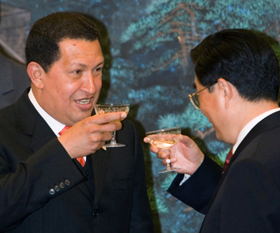Venezuela's President Hugo Chavez (L) toasts China's President Hu Jintao as they attend a signing ceremony at the Great Hall of the People in Beijing August 24, 2006. Venezuela, on a mission to diversify its crude exports and ease its reliance on the U.S. market, hopes to lift crude sales to China to 1 million barrels per day within a decade, Chavez said on Thursday. 