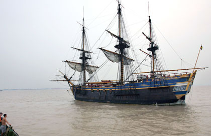 A man looks at a replica of the 18th century Swedish merchant ship Gotheborg at Baoshan Wharf in Shanghai August 28, 2006. 