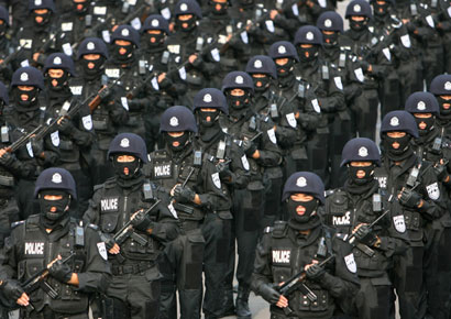 Paramilitary policemen stand in lines during an anti-riot drill in Beijing August 29, 2006. The fight against "extremism, separatism and terrorism" is expected to take centre stage at a summit next month between judges from China, Russia and Central Asia, a Chinese official said on Tuesday