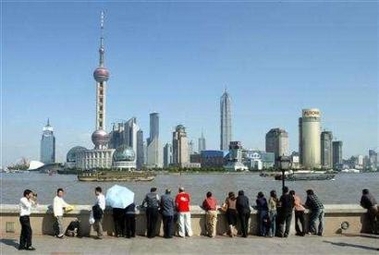 Tourists view Shanghai's business district of Liujiazui in Pudong October 9, 2003. People wearing pyjamas in public, still a common sight in Shanghai, is one of the most irritating aspects of life in China's biggest city, according to an opinion poll of residents.