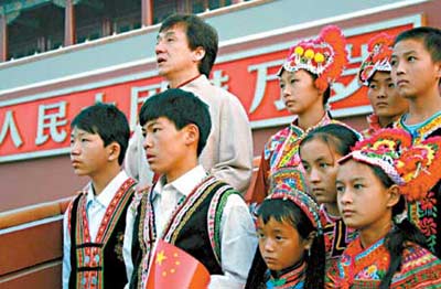 Movie star Jackie Chan joins a group of 15 minority students at a flag-raising ceremony in Tian'anmen Square yesterday in Beijing. The poverty-stricken students, from Wuding and Yongren counties in Yunnan Province, are the beneficiaries of a charity programme sponsored by Commercial Bank of China and Huayi Brothers. The project is dedicated to helping children in underdeveloped regions stay in school. (Xinhua)