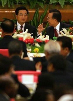 Chinese Premier Wen Jiabao, right, speaks with President Hu Jintao, left, after toasting Communist Party leaders and 300 foreign diplomats at a National Day reception at the Great Hall of the People in Beijing, China Sept. 2006.