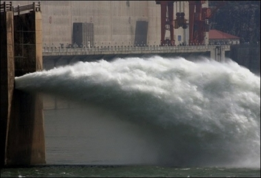 Water pours from a valve in the Three Gorges Dam project in Yichang. China has announced it will relocate around 300,000 more people than planned to make way for the Three Gorges Dam, bringing the total number to over 1.4 million.(AFP